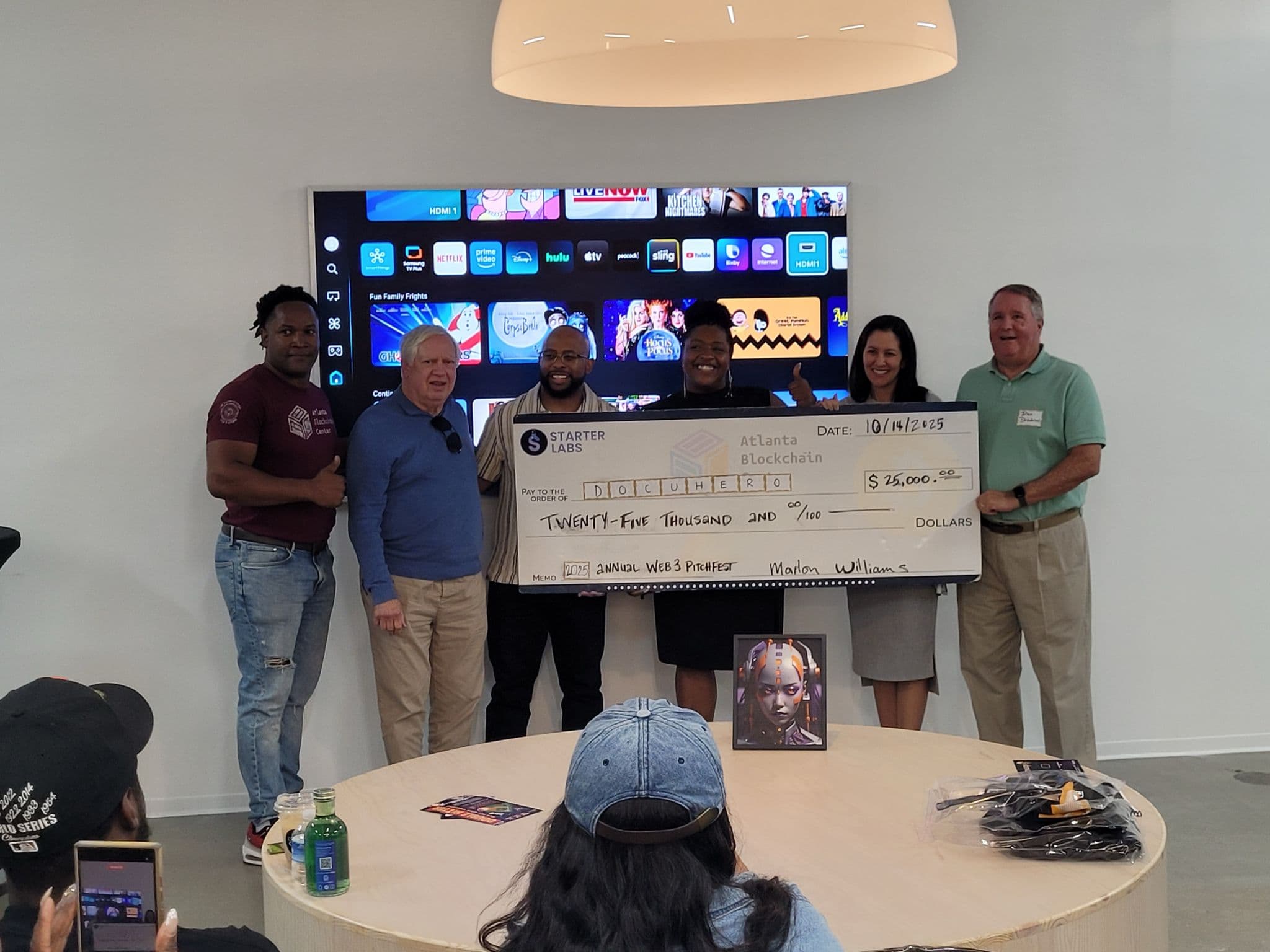 The check presentation to DocuHero at the Atlanta Blockchain Center Pitchfest